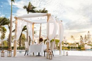 a white wedding altar with a table and chairs at Nam Cuong Nam Dinh Hotel in Nam Ðịnh