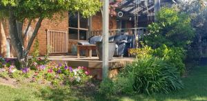 a garden with a statue in front of a building at Quiet Room own Bathroom at home in Golden Square in Golden Square