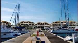 a marina with boats docked in a harbor at Airport 25 min ByWalk-Big Port 10 min by bus-Bus 1 min by walk to city&beaches-Touristic port at 1 min by walk - WIFI AIR COND WASH MACHINE -4 pex 2 Rooms veranda&GARDEN-FREE PARKING-GIALLO in Olbia