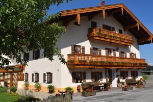 a large white building with balconies on it at Stöcklhof in Siegsdorf