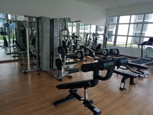 a gym with several rows of treadmills and machines at Desaru Utama Residance Aisy Homestay in Kota Tinggi