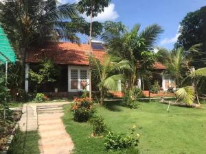
a house that has a tree in front of it at Phu Quoc Kim - Bungalow On The Beach in Phú Quốc
