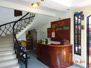 a staircase in a house with a counter and a stair case at Green Hill Guest House in Ba Hòn
