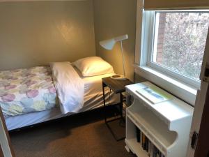 a bedroom with a bed and a window at Portland International Guesthouse in Portland