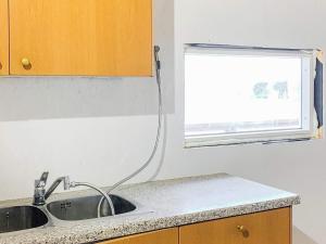 a kitchen with a sink and a window at 6 person holiday home in Dønna in DÃ¸nnes +26 photos