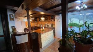 a kitchen with a counter and a large window at Pensiunea Cerbul Carpatin in Bran