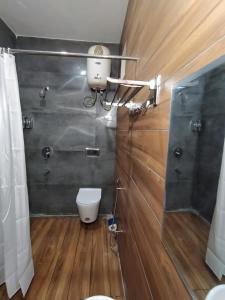a bathroom with a toilet and a shower at WildWoodHome Jibhi in Jibhi