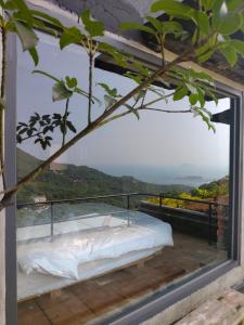 a bed on a balcony with a view at 雜院-晴海 新北市民宿證號333號 in Jiufen