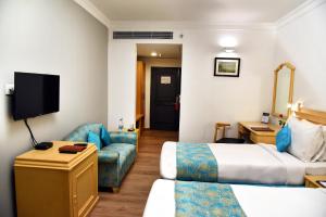 Postel nebo postele na pokoji v ubytování Golden Parkk Hotel