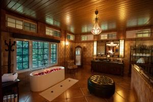 a large bathroom with a tub and a sink at Coorg Wilderness Resort & Spa in Madikeri