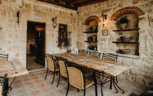 a dining room with a wooden table and chairs at Melekler Evi Cave Hotel in Urgup
