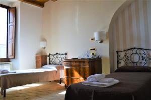 a bedroom with two beds and a sink in it at S. Martin Hotel in Giovinazzo