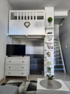 a room with a bunk bed and a desk with a tv at Apartment GS CENTAR in Gospić