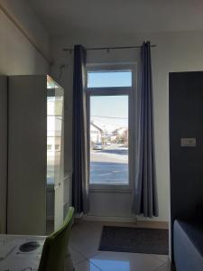 a room with a window with a table and a chair at Apartment GS CENTAR in Gospić