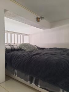 a bedroom with a bed with a black blanket at Apartment GS CENTAR in Gospić +5 photos