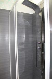 a shower with a glass door in a bathroom at I Cardellini in Mascali