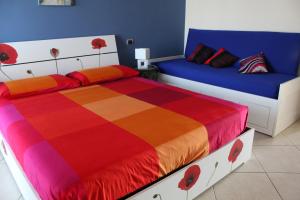 a bedroom with two beds with red flowers on them at I Cardellini in Mascali
