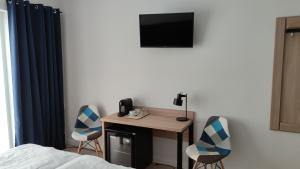Televízia a/alebo spoločenská miestnosť v ubytovaní Hotel ANTARES