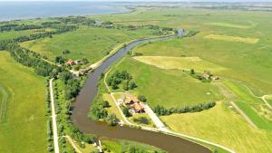 an aerial view of a farm and a river at Rusne Villa in Rusnė