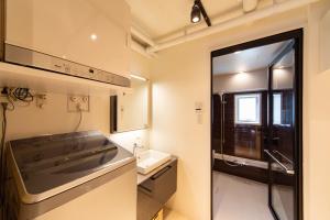 a small bathroom with a sink and a counter top at NIYS apartments 07 type in Tokyo +18 photos