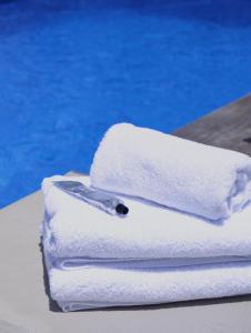 a stack of towels with a knife on top of them at THE BAHI VILLA - Adults Only B&B in Les Trois-Îlets