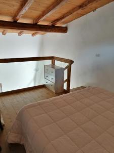 a bedroom with a bed and a wooden ceiling at I Lecci in Lerici