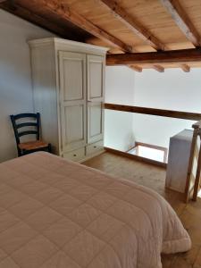 a bedroom with a bed and a cabinet in a room at I Lecci in Lerici