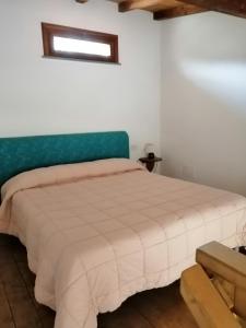 a bedroom with a bed with a blue headboard at I Lecci in Lerici