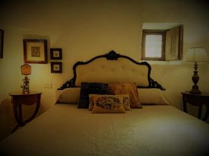 a bedroom with a large bed with pillows on it at Trulli Fogliarella in Ostuni