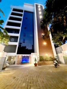 a large building with blue lights on the side of it at Iswarya Residency in Kottayam