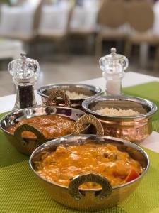 a table with four trays of food on a table at Alexandria Hotel in Pryluky