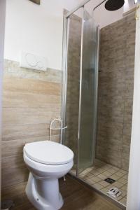a bathroom with a toilet and a shower at Il Trullo di Heidi in Ostuni