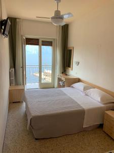 Postel nebo postele na pokoji v ubytování Hotel Sorriso