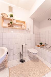a white bathroom with a toilet and a sink at Design Apartment Zentral & Rooms - Toplage am Opernhaus in Nürnberg