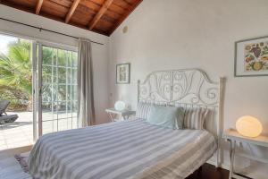 a bedroom with a bed and a large window at La Camuesa-Adults Only in Los Llanos de Aridane