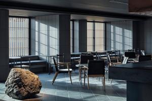 a restaurant with chairs and tables and windows at hotel tou nishinotoin kyoto in Kyoto