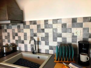 a kitchen counter with a sink in a kitchen at Salty Kisses and Sandy Toes in Firopótamos