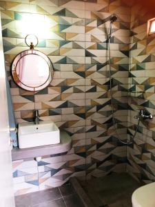 a bathroom with a sink and a mirror at Salty Kisses and Sandy Toes in Firopótamos