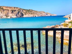 a view of the ocean from a balcony at Salty Kisses and Sandy Toes in Firopótamos