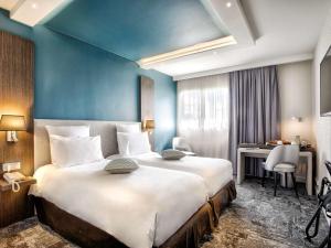 Postel nebo postele na pokoji v ubytování Mercure Cabourg Hôtel & Spa