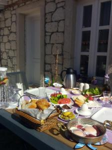 a table topped with a table with food on it at Fatma Hanım Konağı Alaçatı in Izmir