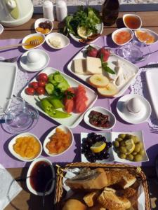 a table with plates of food on a purple table cloth at Fatma Hanım Konağı Alaçatı in İzmir