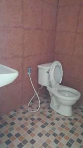een badkamer met een toilet met een slang bij โคโค่เขาค้อรีสอร์ท in Campson
