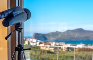 een camera op een statief voor een raam bij Luxury 6-Bedroom Villa With Private Pool- Villa Prigipessa in Chania