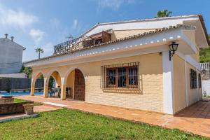 a house with a balcony on top of it at Casa La Albaida, Estación de Cortes de la Frontera in Cortes de la Frontera