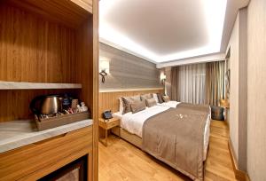 a bedroom with a bed and a television in it at Lady Diana Hotel in Istanbul +61 photos
