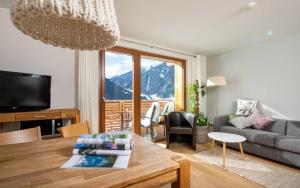 a living room with a couch and a table at Tanafreida Berg-Refugium in Sankt Gallenkirch