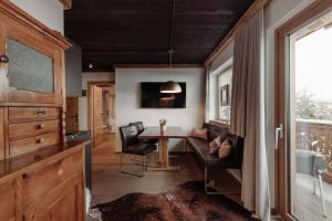 a dining room with a table and chairs and a window at Hoagascht in Flachau