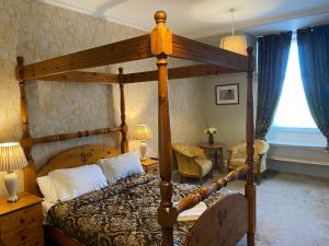 A bed or beds in a room at Ernespie House Hotel