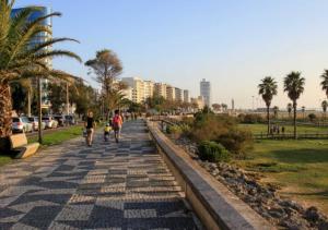 a group of people walking down a sidewalk at Casa do Mar in Figueira da Foz